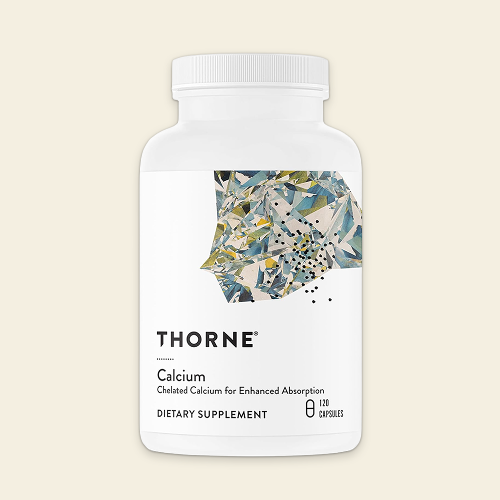 Thorne Calcium dietary supplement bottle on a beige background