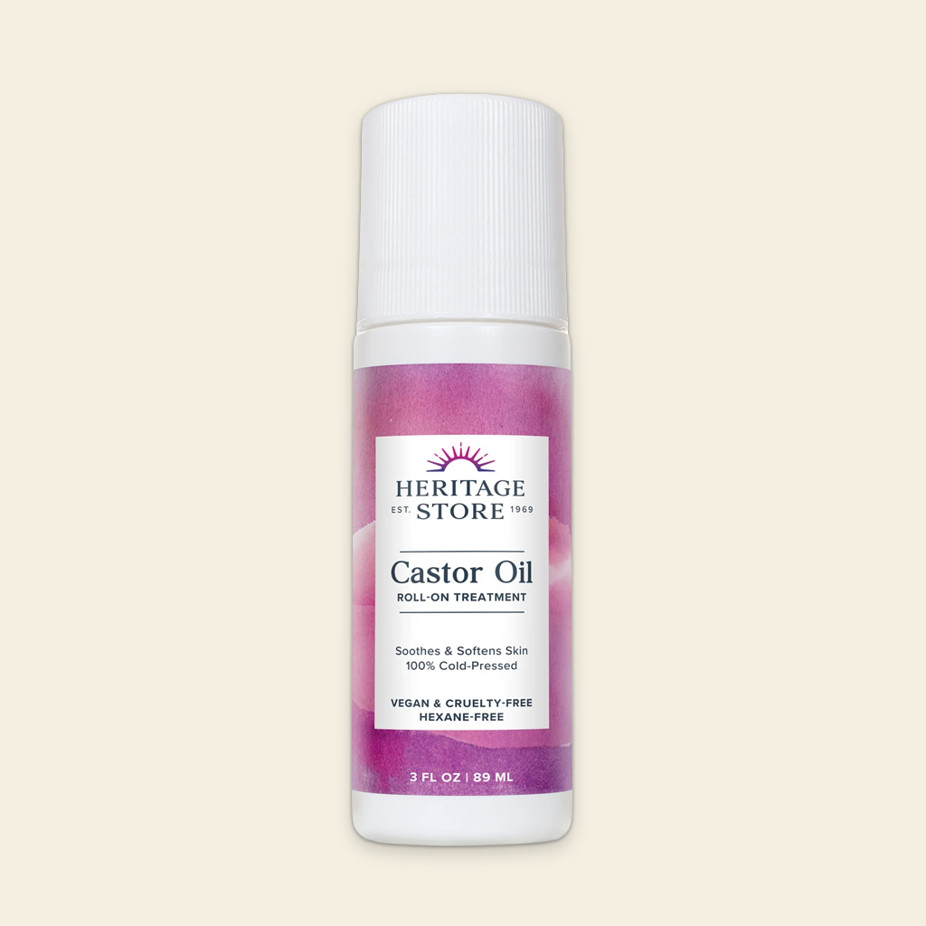 Heritage Store Castor Oil roll-on bottle on a beige background