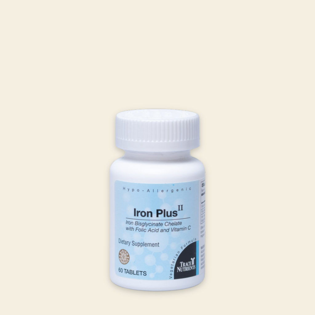 Bottle of Iron Plus II dietary supplement on a beige background
