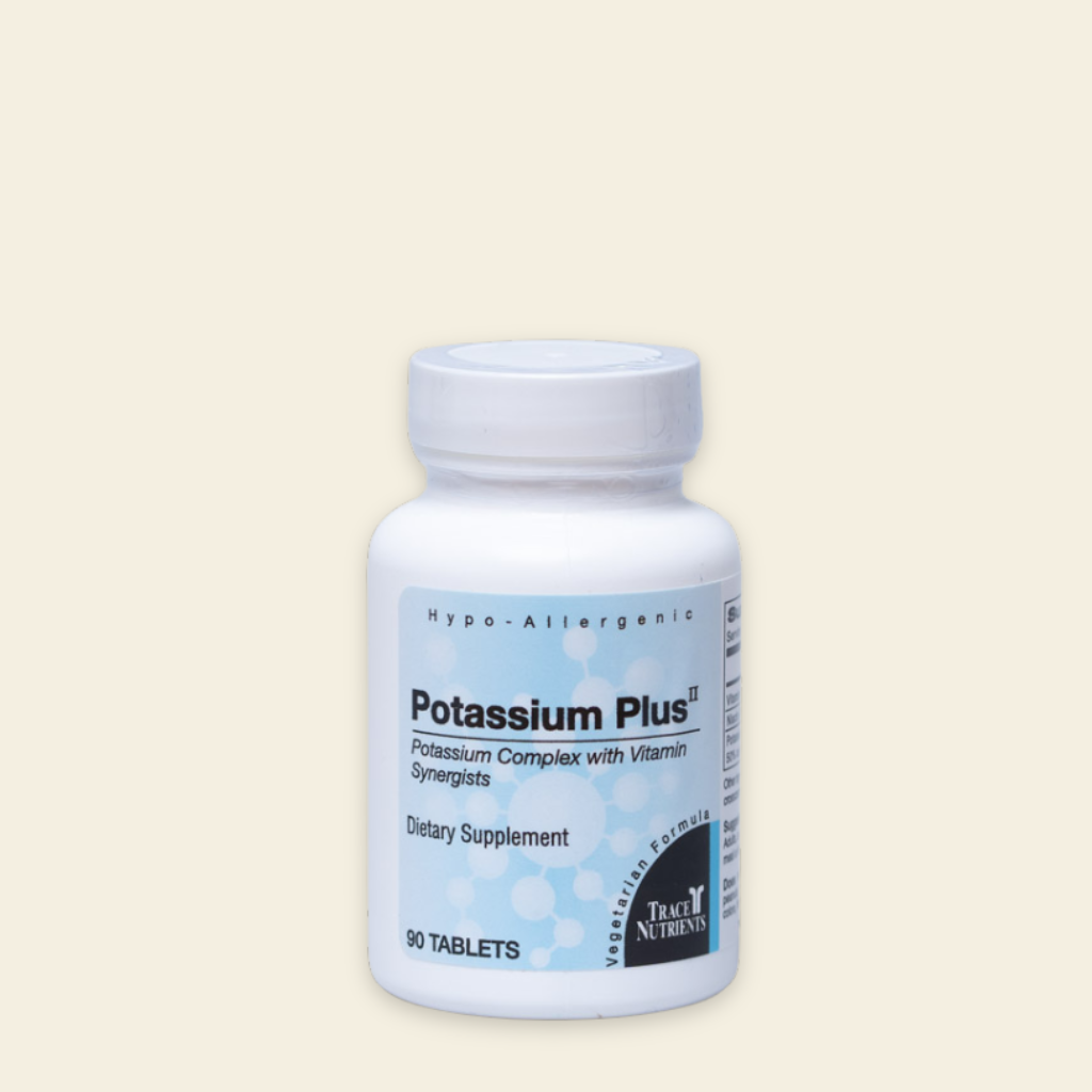 Supplement bottle labeled 'Potassium Plus' on a beige background
