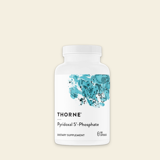 Thorne dietary supplement bottle with blue floral design on a beige background