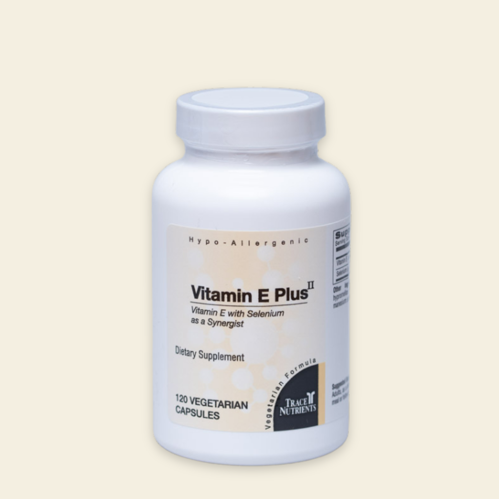 Supplement bottle labeled 'Vitamin E Plus II' on a beige background