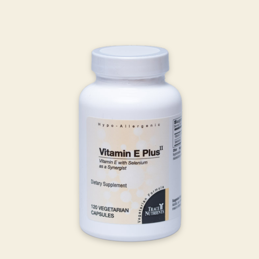 Supplement bottle labeled 'Vitamin E Plus II' on a beige background