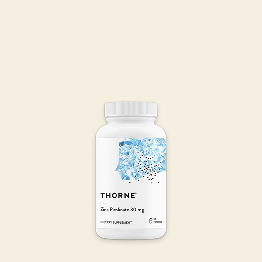 Thorne dietary supplement bottle on a beige background